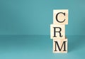 Stack of wooden blocks with the letters CRM on top Royalty Free Stock Photo