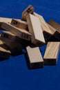 Stack of wooden blocks on table in classic blue color with hard light and marked shadows and the wooden cubes are numbered