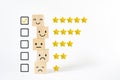 Wooden cubes with mental icon and rating stars, yellow true mark in square checkbox for customer review, satisfaction,