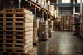 Stack of wooden pallets sitting idle in large empty warehouse Royalty Free Stock Photo