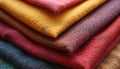 Stack of woven fabric samples. Colorful textile swatches display varied textures and patterns. Different materials are layered Royalty Free Stock Photo