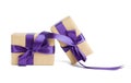 Stack of wrapped boxes in brown kraft paper and tied with silk purple ribbon Royalty Free Stock Photo