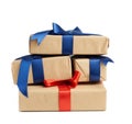 Stack of wrapped boxes in brown kraft paper and tied with silk ribbon, holiday gifts Royalty Free Stock Photo