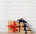 Stack of wrapped boxes in brown kraft paper and tied with silk ribbon Royalty Free Stock Photo