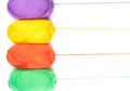 Stack of yarn skeins in yellow, orange, green, purple colors