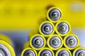 Stack of yellow AA batteries close up abstract color background Royalty Free Stock Photo