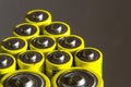 Stack of yellow AA batteries close up, electricity storage concept