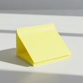 A stack of yellow adhesive sticky notes with a partially curled top sheet is positioned o Royalty Free Stock Photo
