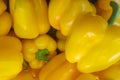 Stack of yellow bell peppers on a market stall Royalty Free Stock Photo