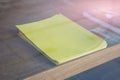 Stack of yellow blank empty paper on table Royalty Free Stock Photo