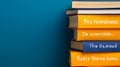 Stack of Yellow and Blue Books Against a Teal Background Royalty Free Stock Photo