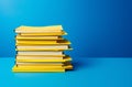 Stack of yellow folders with documents on a blue background.