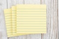 Yellow lined index cards on wooden desk