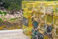 Stack of yellow lobster traps on short dock Royalty Free Stock Photo