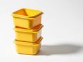 Stack of yellow plastic containers isolated on white background Royalty Free Stock Photo
