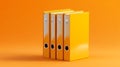 Stack of yellow ring binders isolated on an orange background Perfect for organization office and storage concepts Royalty Free Stock Photo