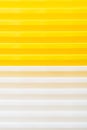 Stack of yellow and white recycled plastic containers. Duocolor background Royalty Free Stock Photo