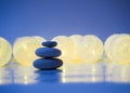 Stack of Zen stones on abstract dark background of Christmas garlands. Relax still Life with folded stones. Zen pebbles Royalty Free Stock Photo