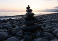 Stack of zen stones on the beach at sunset, beautiful seascape. Made of stone tower as rest balance vacation concept.