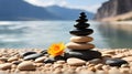 Stack of zen stones and flower on the beach, closeup Royalty Free Stock Photo