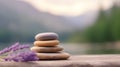 Stack of zen stones and lavender flowers on a wooden table Royalty Free Stock Photo