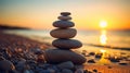 Stack of zen stones on pebble beach at sunset Royalty Free Stock Photo