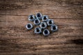 Stack of zinc plated self locking hexagon nuts on a dark wood texture background Royalty Free Stock Photo