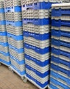 Stackable plastic pallets on wheeled dollies. Royalty Free Stock Photo