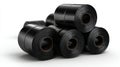 Stacked black rolls of industrial material on a white background, showcasing texture and pattern in a studio setting. Royalty Free Stock Photo