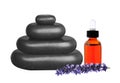 Stacked black stepping stones, essential oil and lavender flower