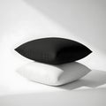 Stacked black and white pillows isolated on white background Royalty Free Stock Photo
