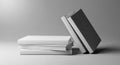 Stacked blank white and dark grey hardcover books leaning image Royalty Free Stock Photo