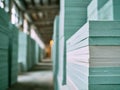 Stacked blue foam insulation panels arranged in rows inside a warehouse with a blurred background highlighting industrial storage Royalty Free Stock Photo