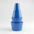 Stacked blue plastic containers with conical and cylindrical shapes Royalty Free Stock Photo