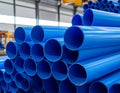 Stacked blue plastic pipes in an industrial warehouse setting plumbing Royalty Free Stock Photo