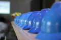 Stacked blue safety helmets on the shelf in the office, stock photo