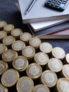 stacked books, calculator, pen and mexican coins of ten pesos Royalty Free Stock Photo