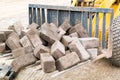 Stacked bricks on scoop of excavator