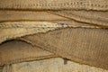 Stacked burlap coffee bags of different textures and colors of brown - background