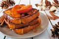 Stacked caramel apple cinnamon french toasts. Table scene on a white wood background. Royalty Free Stock Photo