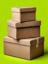Stacked cardboard boxes on a green background. Royalty Free Stock Photo