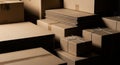Stacked cardboard boxes and packaging materials in a dimly lit storage area shipping delivery Royalty Free Stock Photo