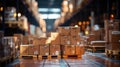 .Stacked cardboard boxes on pallets line the aisles of a busy warehouse, with warm lighting and the blur of active logistics work