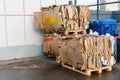 Stacked cardboard and paper products for further processing. A waste paper recycling company. Paper garbage at the recycling plant Royalty Free Stock Photo