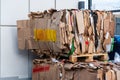 Stacked cardboard and paper products for further processing. A waste paper recycling company. Paper garbage at the recycling plant Royalty Free Stock Photo