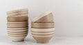 Stacked Ceramic Bowls with Brown and White Stripes, Kitchen Decor, Minimalist Style. Royalty Free Stock Photo