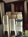 Stacked chairs wait in temple& x27;s quiet corner. Royalty Free Stock Photo