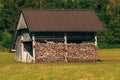 Stacked chopped firewood in farm shed for winter season