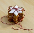 Stacked cinnamon stars with white icing packed with red and white ribbons