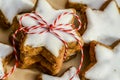 Stacked cinnamon stars with white icing packed with red and white ribbons